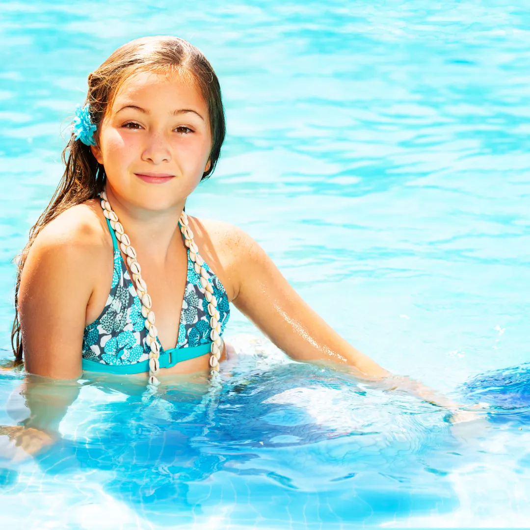 Child swimming with a mermaid tail